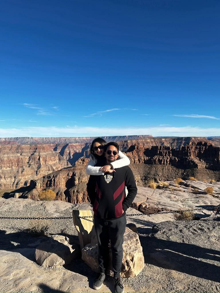 Two travellers posing together above the canyon at Grand Canyon West