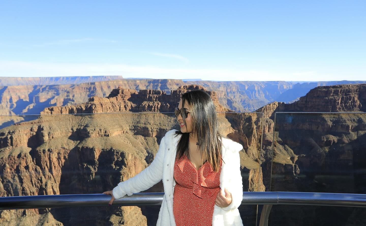 Traveller beside a protected canyon overlook railing at Grand Canyon West