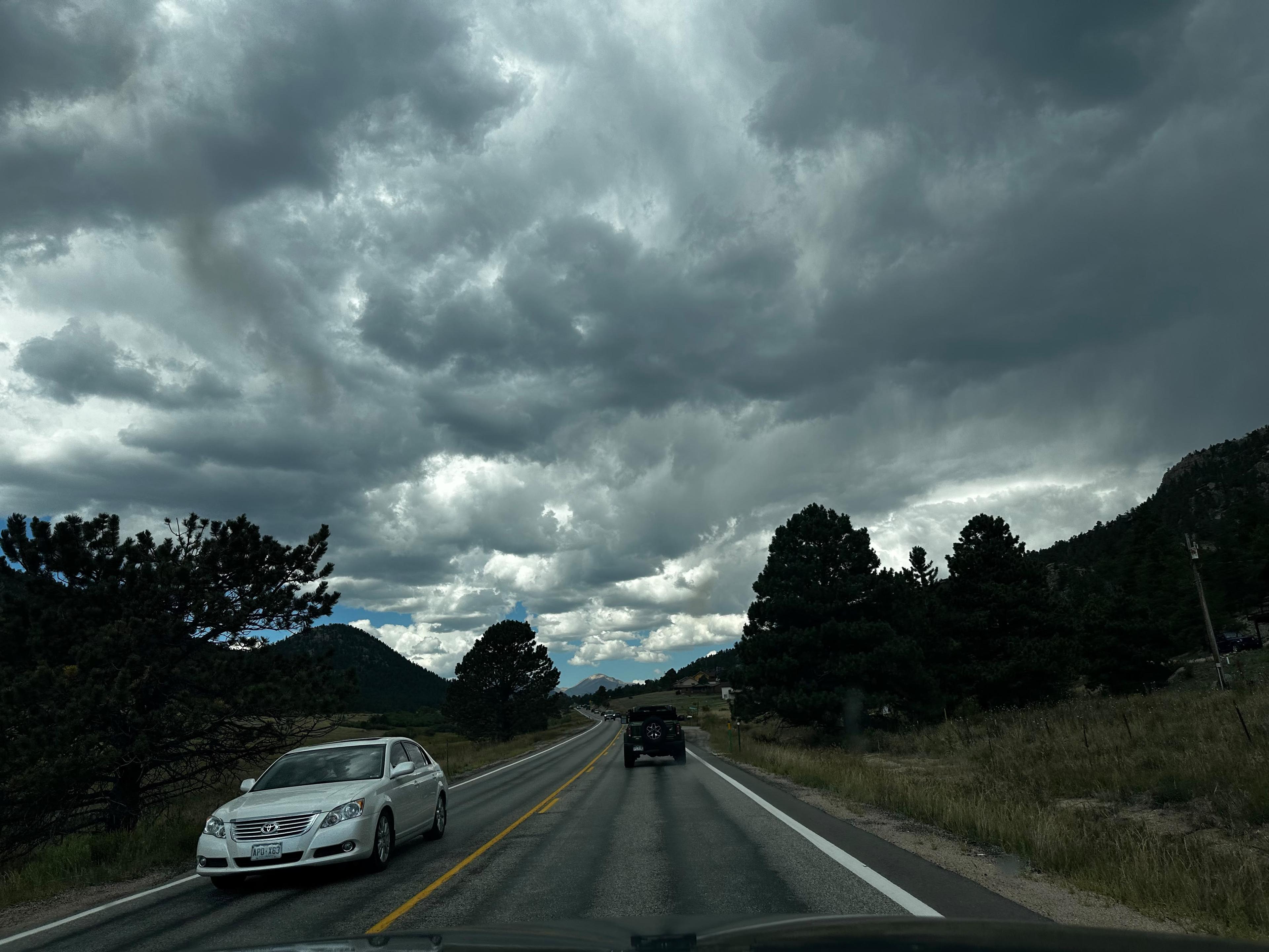 Storm clouds gathering above a road through Rocky Mountain National Park