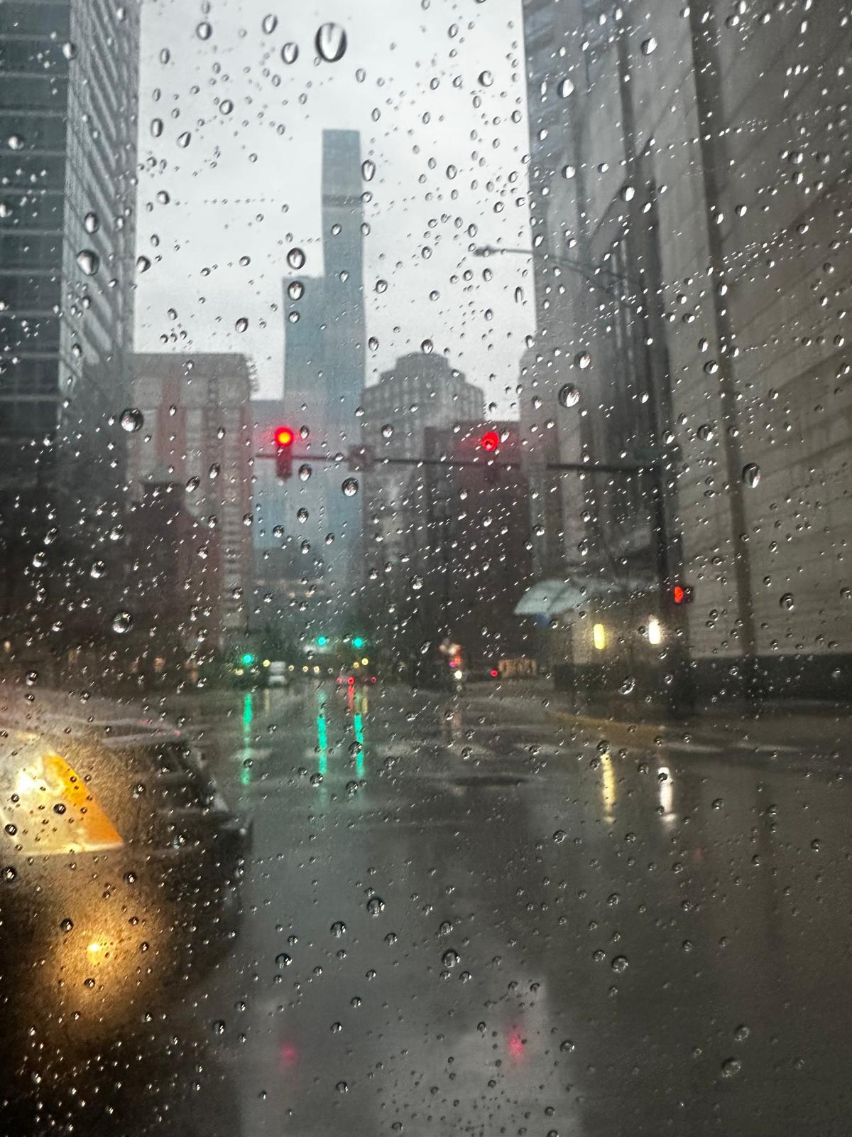 Rainy Chicago traffic and city lights seen through a car window