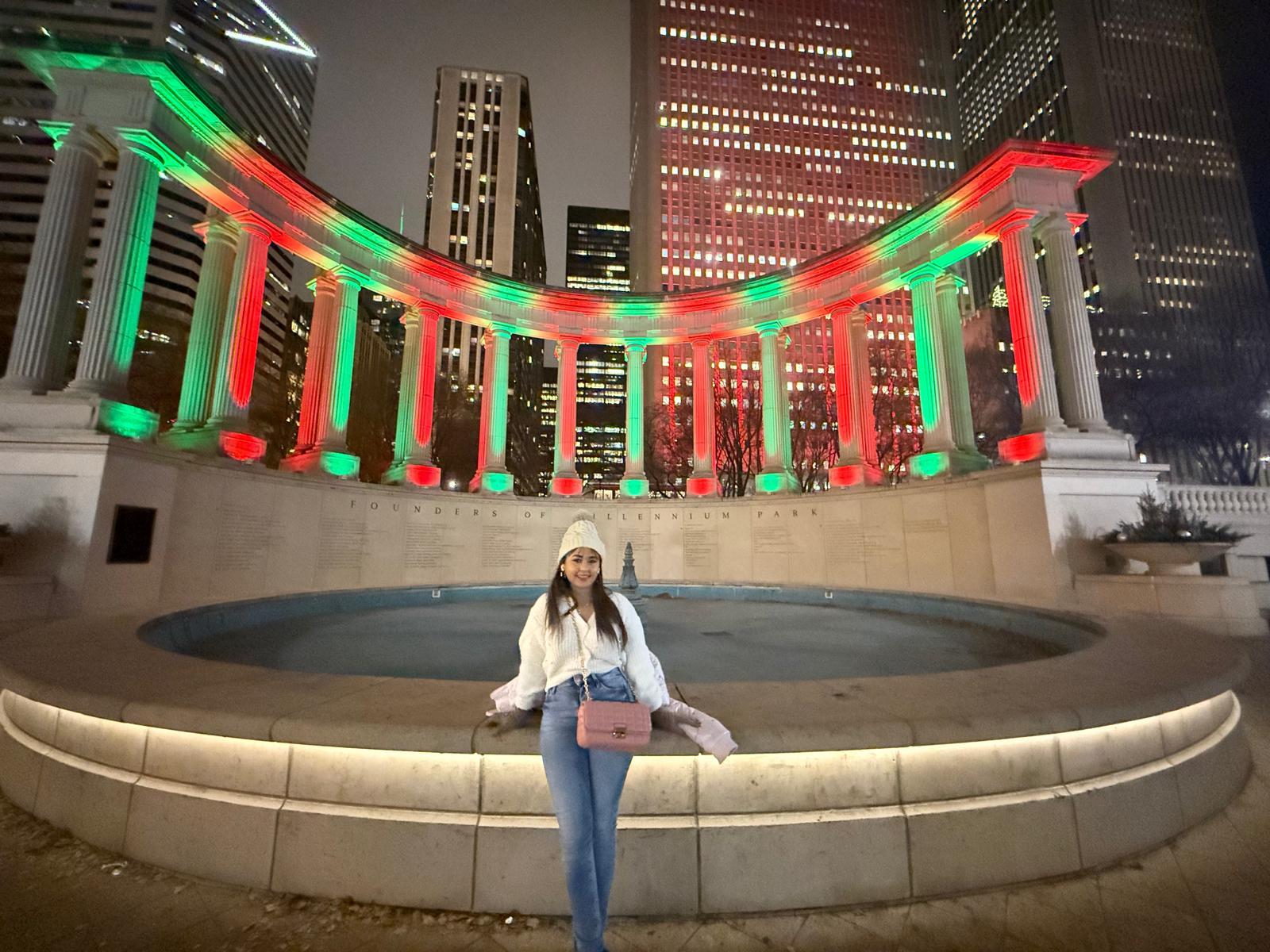 Traveller in front of a red-and-green illuminated Chicago colonnade