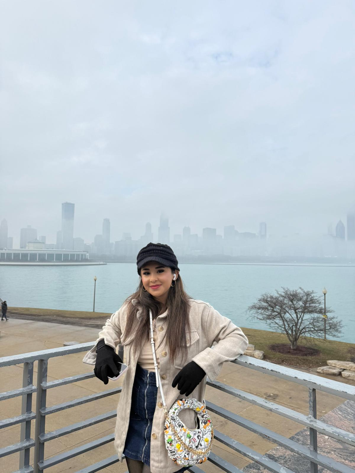 Traveller overlooking the foggy Chicago skyline from the lakefront