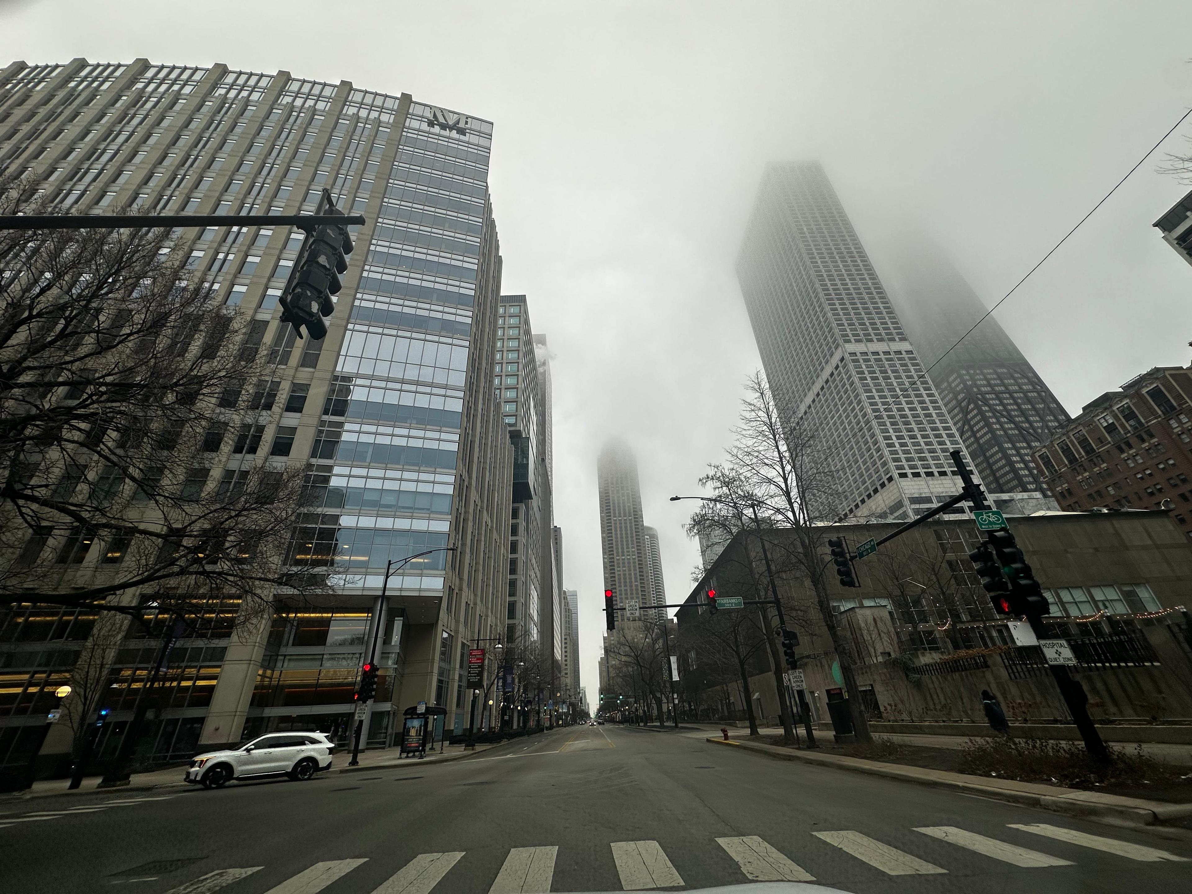 Foggy downtown Chicago street surrounded by high-rise buildings