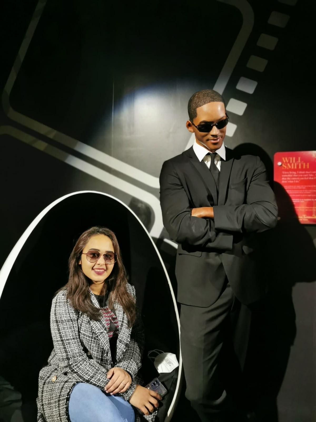 Personal portrait beside a suited film-themed wax figure