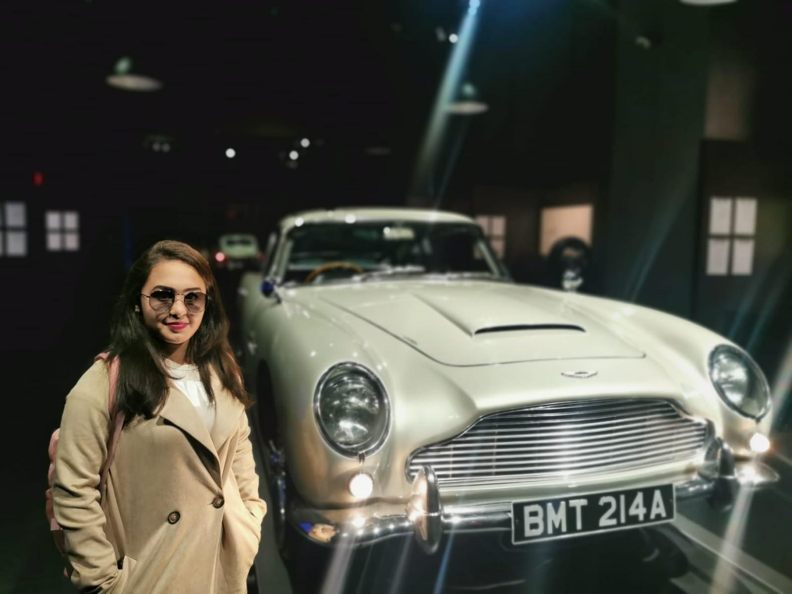 Classic silver spy-film sports car displayed indoors