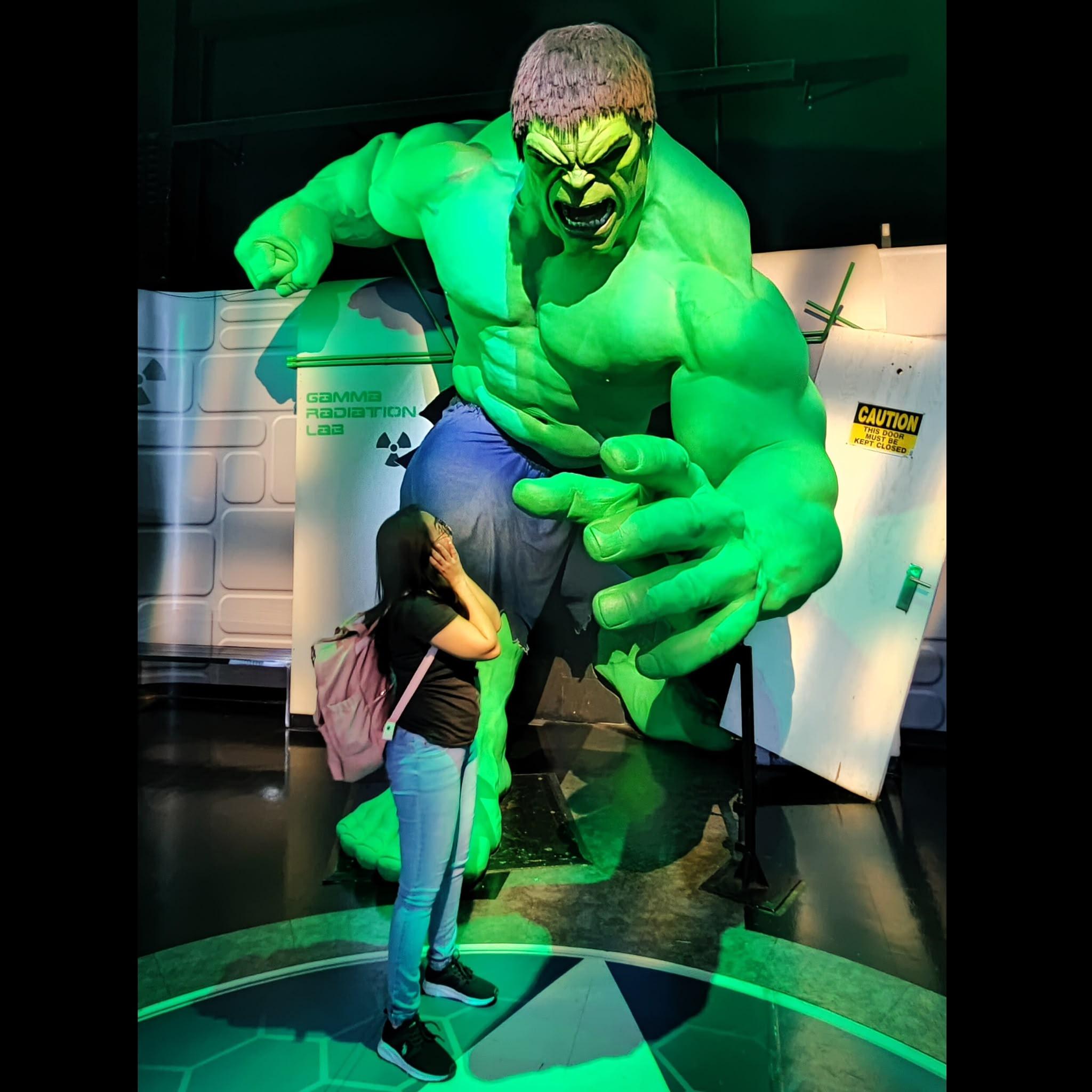 Superhero-themed wax display with a large green fantasy character