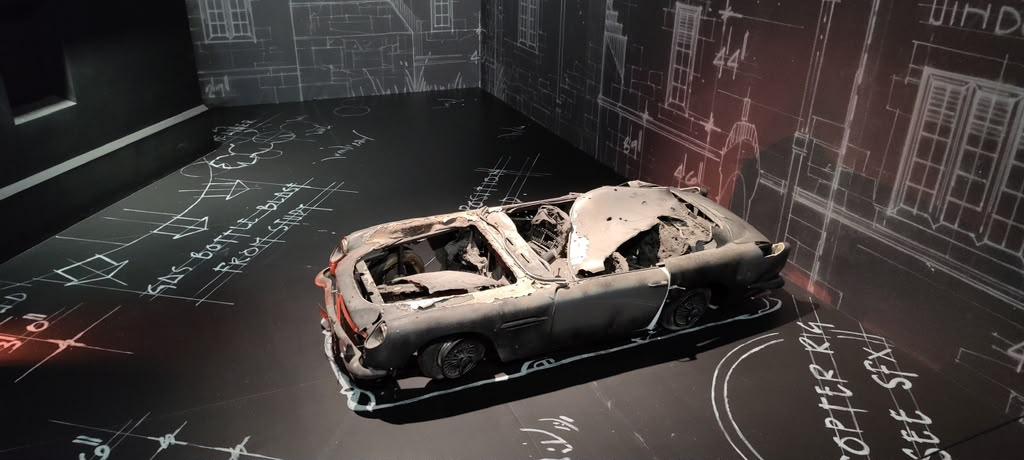 Damaged stunt car displayed with technical markings