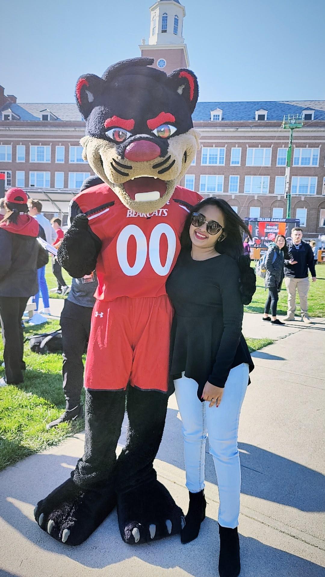Traveller posing beside the University of Cincinnati Bearcat mascot