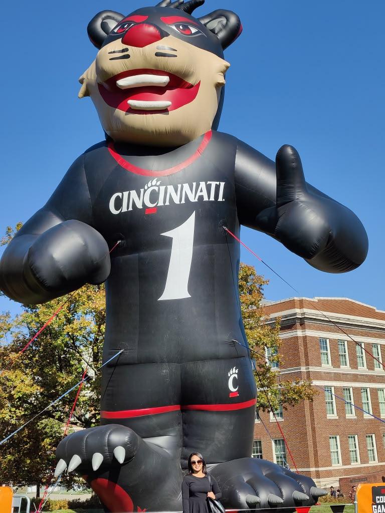 Large inflatable Cincinnati Bearcat mascot beneath a blue sky