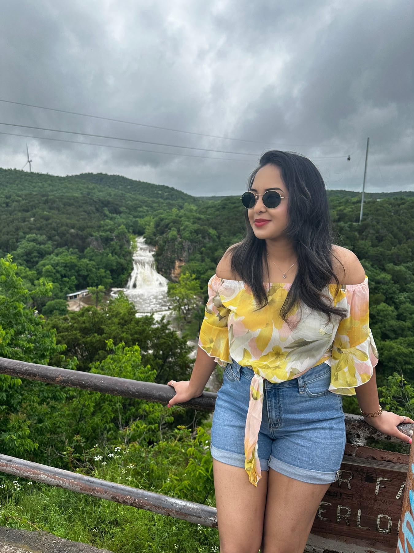 Traveller overlooking Turner Falls and the surrounding green hills