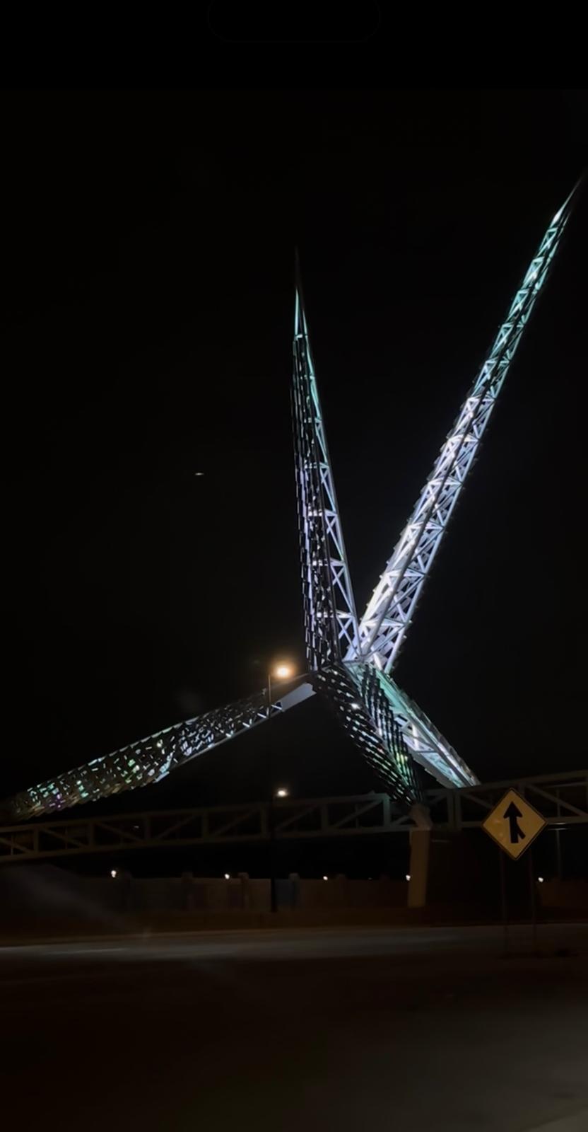 Illuminated Oklahoma City pedestrian bridge against the night sky