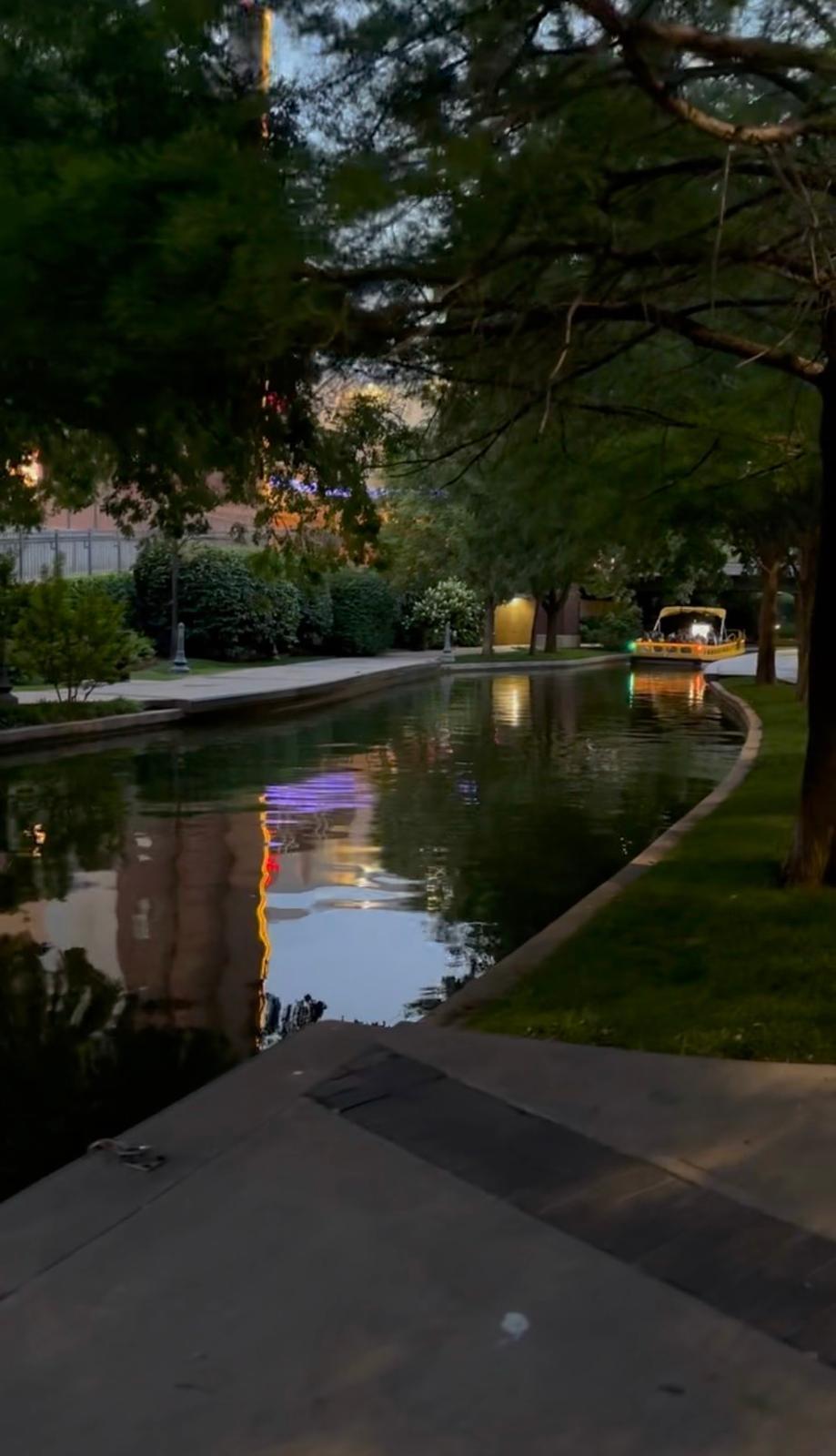 Quiet landscaped section of the Bricktown Canal at dusk