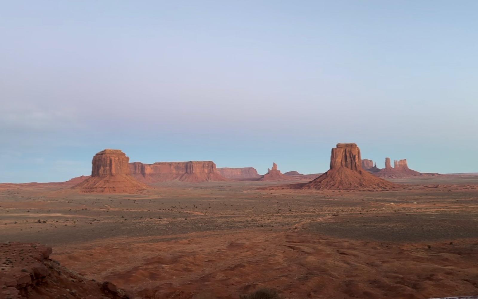 Pastel morning panorama across Monument Valley mesas and buttes