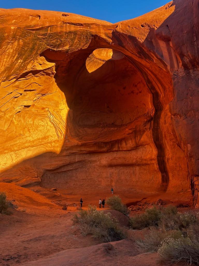 Large sandstone alcove glowing in warm desert light