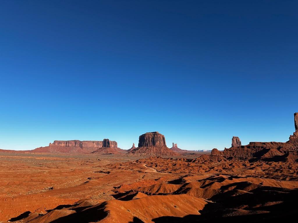 Broad Monument Valley desert floor surrounded by distant formations