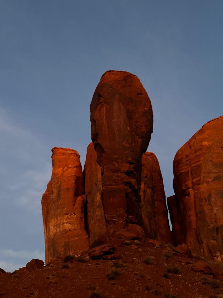 Cluster of narrow Monument Valley rock spires during blue hour