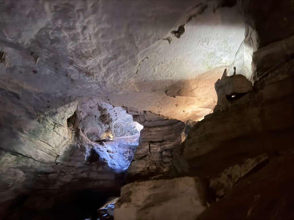 Natural cave opening framed by rough limestone walls