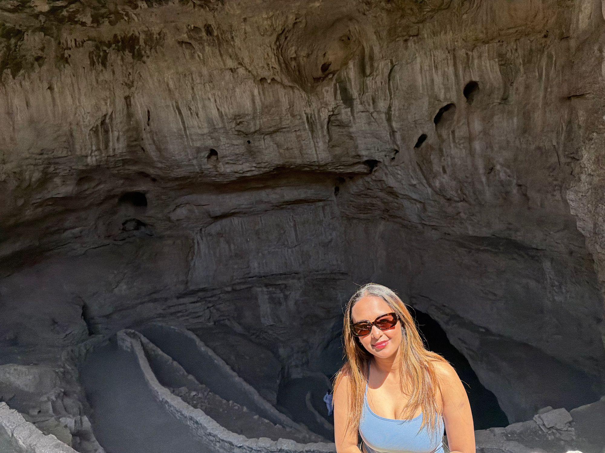 Traveller beside the rocky Natural Entrance at Carlsbad Caverns