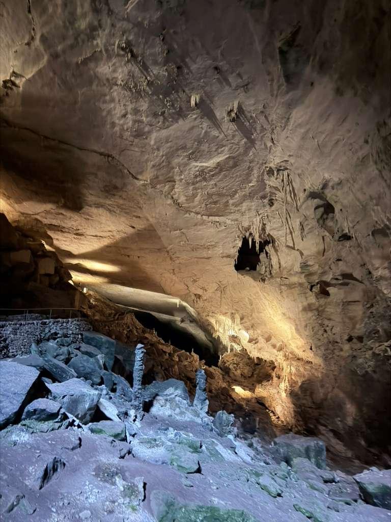 Rocky cavern passage with warm pathway lighting
