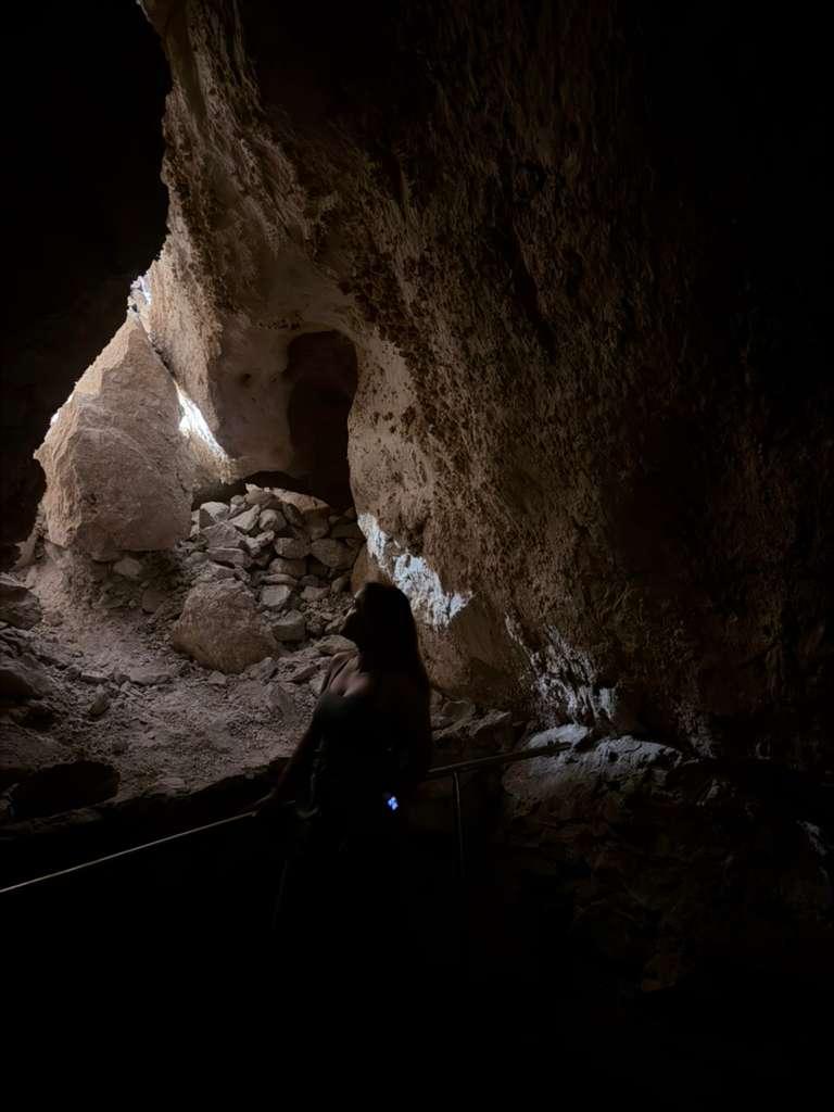 Dark figure beside a natural opening inside Carlsbad Caverns
